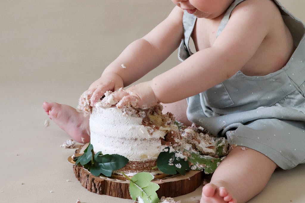 Capture the joy of a baby experiencing a cake smash, making delightful mess and memories.